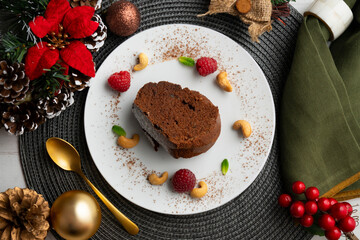 Delicious piece of chocolate cake seen from an overhead perspective. Christmas decoration table.