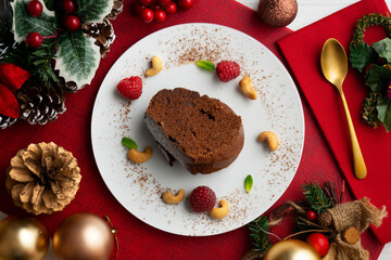 Delicious piece of chocolate cake seen from an overhead perspective. Christmas decoration table.