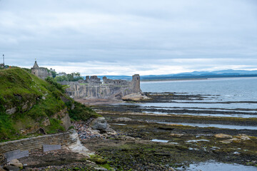 The ancient ruins and towers of St Andrews Castle on the east coast of Scotland and on the shore front of the town of St Andrews