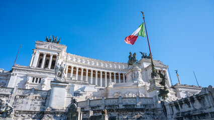 The Vittoriano, a grand marble monument in Rome, Italy, honors Victor Emmanuel II. The Italian flag...