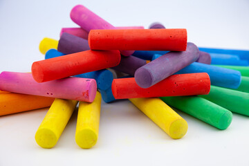 Set of colorful chalks for the board and the street. Drawing chalk stick, back to school background. Heap of different draw equipment.