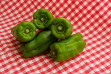 Fresh green bell peppers on the cloth