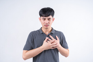 Portrait of handsome Asian man with chest pain. Medical and healthcare concept on white background.