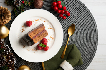Delicious original sacher chocolate cake from an overhead perspective. Table with Christmas...