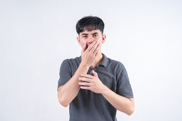 Portrait of handsome Asian man with nausea and vomiting symptoms. Medical and healthcare concept on white background.