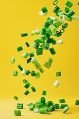 fresh green floating spring onions, falling against vibrant yellow background dynamic image