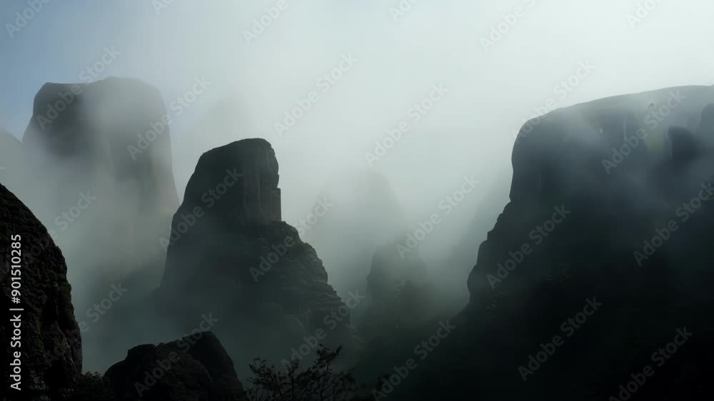 Poster lost in the fog the imposing rock formations seem to take on a life of their own a silent and ancien