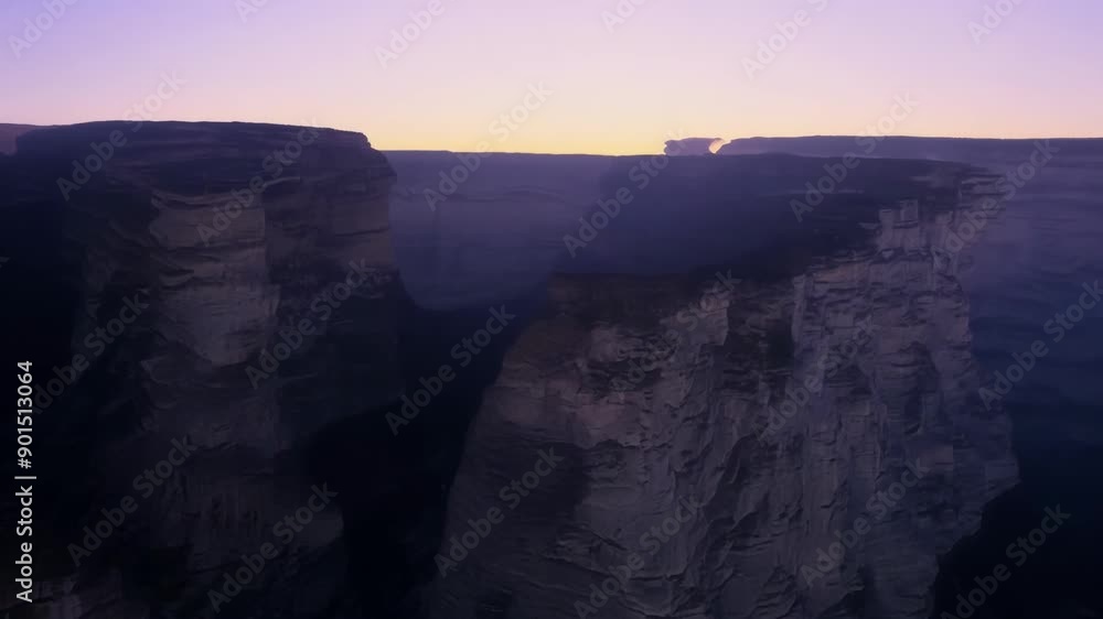 Poster Looking out at the cliffs from a distance the fading light gives them a mystical quality.