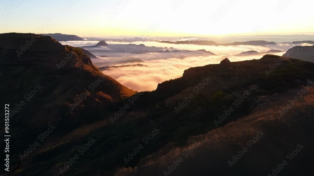 Poster The valleys come alive with the first light of day casting a warm and inviting glow across the rugged terrain.