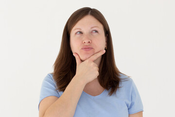 Fototapeta premium Closeup photo of amazing lady looking up empty space deep thinking creative person arm on chin wear casual blue t-shirt isolated white color background