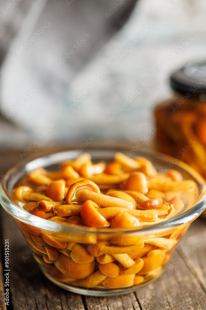 Wall mural pickled nameko mushrooms.traditional japanese mushrooms in bowl on wooden table.