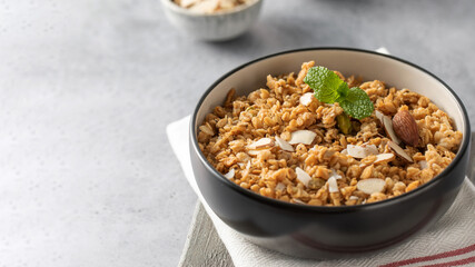 Crispy homemade granola with sliced almonds in a bowl. Healthy food. Copy space