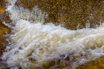 caída de agua de río con movimiento de espuma y salpicaduras