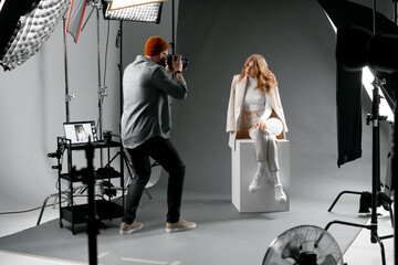 Professional studio for fashion photoshoot with model and photographer capturing stunning images