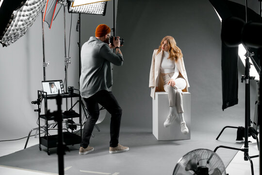 Professional studio for fashion photoshoot with model and photographer capturing stunning images