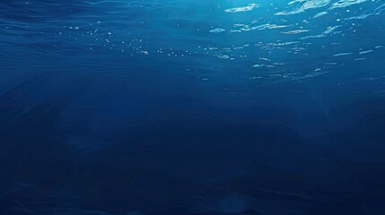 Deep blue water background with subtle light reflections, ideal for a soothing and serene setting.