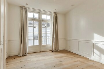 Interior of empty living room with large bright window and curtains by closed door in modern apartment with white walls and hardwood floor