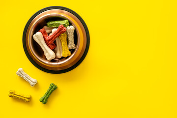 Food and treats for pets. Bowl full of dog chew bones