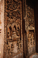 Carved bas-relief on wooden furniture and doors in Cambodia