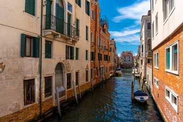 Venice, Italy - June 04, 2024: Peaceful Venice Canal Framed by Colorful Buildings.