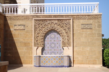 An engraving moroccan wall at the mosque with a small fountain of Hassan Tower in Rabat.