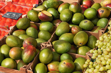 Green ripe mango in a box at the market