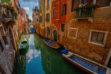 Venice, Italy - June 03, 2024: Peaceful Venice Canal with Docked Boats.