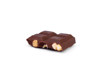Milk chocolate with whole hazelnuts isolated on white background.