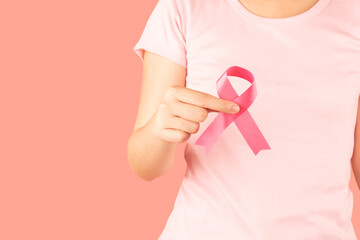 Breast Cancer Awareness Month in October. Woman hand holding pink ribbon awareness for support...