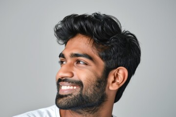 Fototapeta premium Man, hearing aid, studio profile for ear, wellness, and solution on white with smiling. Smile, sound implant, and health for disabled patient, audio tech, and hearing.