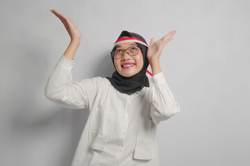 Smiling Woman in White Shirt and Hijab Gesturing with Hands
