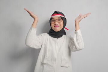 Smiling Woman in Hijab with Hands Raised in a White Shirt