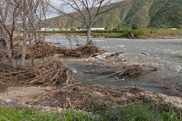 A photo of a river in flood that eroded the river bank near Worcester, Western Cape, South africa.