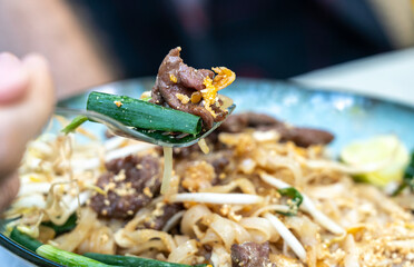 Pad thai, phat thai, or phad tha asian noodles, chinese rice pasta with meat in thailand...
