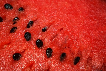 Summer refreshing background - juicy ripe watermelon with seeds close-up