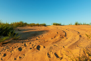 A trace on a sand dune from a passing car