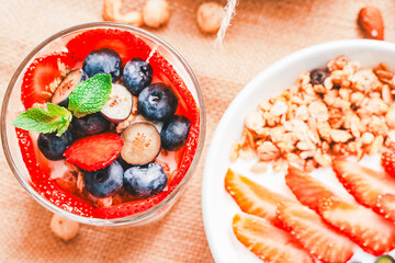 Berry dessert, parfait xs strawberries, blueberries, yogurt and granola on a canvas napkin. Delicious, healthy and luxurious breakfast Selected Focus
