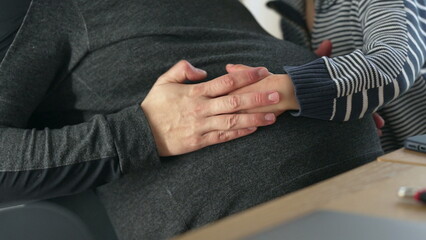 Pregnant woman and child embracing indoor setting, close-up of faces, tender and loving moment, family bond, natural light, peaceful scene, maternal connection, quiet home environment, warmth and care