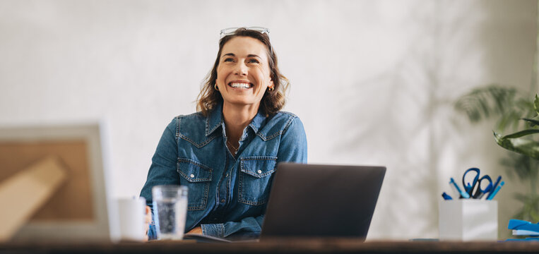 Successful businesswoman embracing her achievements - Powered by Adobe