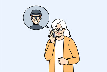 Elderly woman talking to telephone scammer who is trying to find out bank account password. Telephone scammer calls grandma, intimidating and forcing to provide personal information or using blackmail
