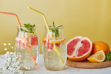 Summer cocktail with grapefruit and orange. Low alcohol, zero proof drinks concept, decorated with...