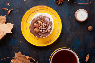 Aesthetics Chocolate Pavlova cake with nuts, Tea Cup background. Autumn tea time vibes background
