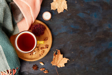 Autumn-Inspired hot beverage, among dry leaves and walnuts. Healthy snack. Fall theme background
