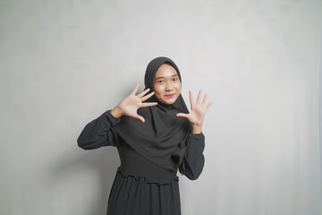 Young Woman in Black Hijab with Open Hands