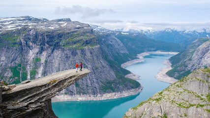 Trolltunga, Norway, A View From The Edge, couple of men and women on top of a mountain edge