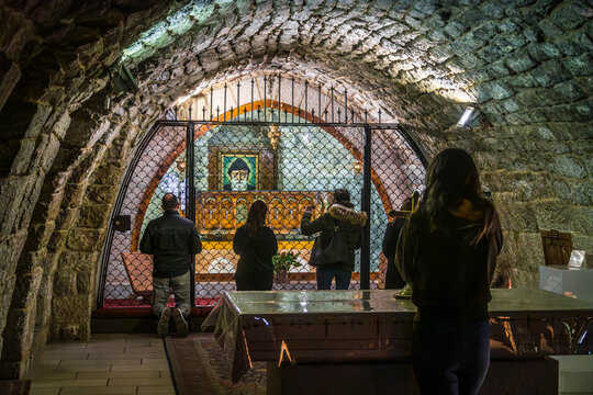 The Saint Charbel Tomb in Aannaya, Lebanon, famous for Maronite priest, with religious Christian people during worship. 
