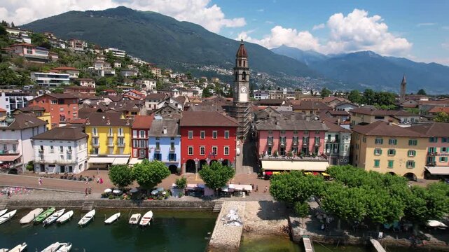 Switzerland Ascona Aerial 4K Video Drone Flight Over Clock Tower Bell Tower Colorful Houses Waterfront Promenade Lake Lago Maggiore Alps Mountains Scenic Ticino Travel