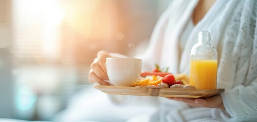 A cozy breakfast scene featuring a cup of tea, fresh fruits, and juice served in a tranquil setting, perfect for relaxation.