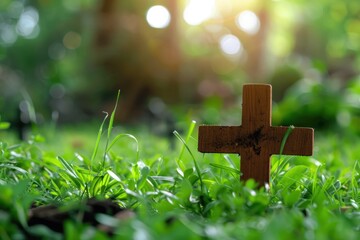 Small wooden cross on green grass lawn, pet's grave