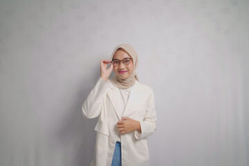 Woman in a White Blazer and Headscarf Adjusting Glasses
